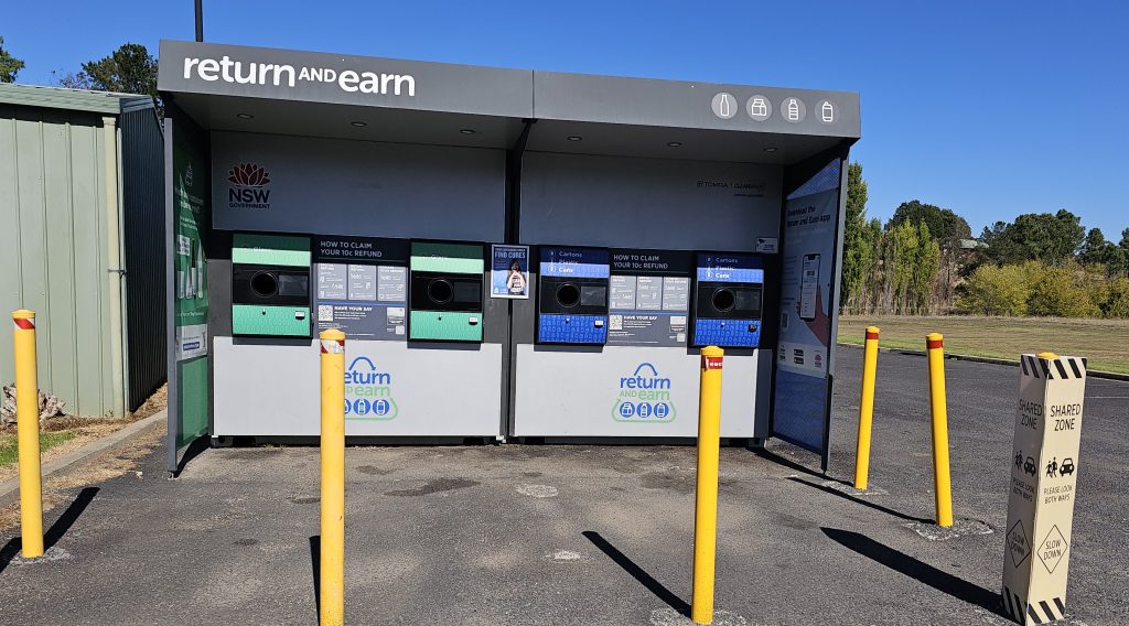 Return and Earn depository shown with surrounding yellow bollards